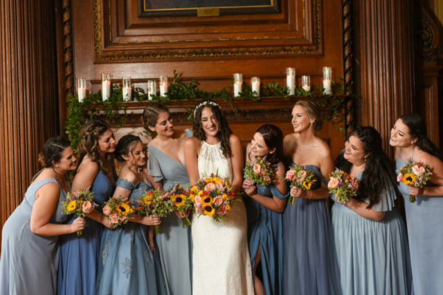 The bride and her bridesmaids in front of the fireplace at the Mutter Museum in Philadelphia