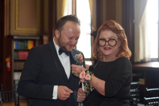 Mother of the Groom pinning on the Groom's boutonniere