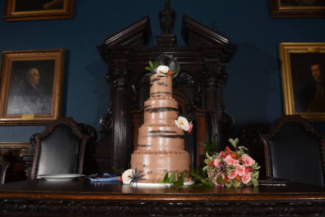 four tiered chocolate wedding cake with accenting touches of wildflowers