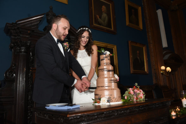The bride and groom cut the wedding cake