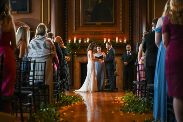 the bride and groom exchange vows in front of the fireplace at the Mutter Museum in Philadelphia